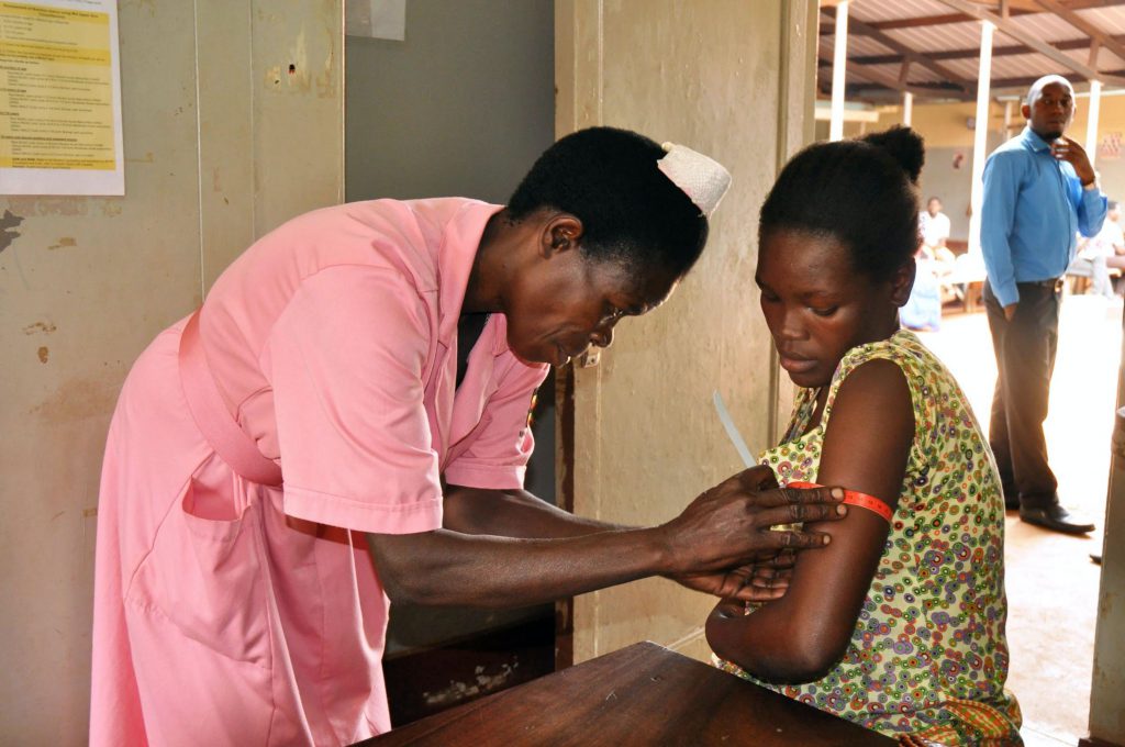 A nurse in Uganda measures the nutrition status of a pregnant women.
