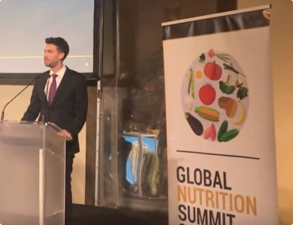 Man standing at podium for Global Nutrition Summit