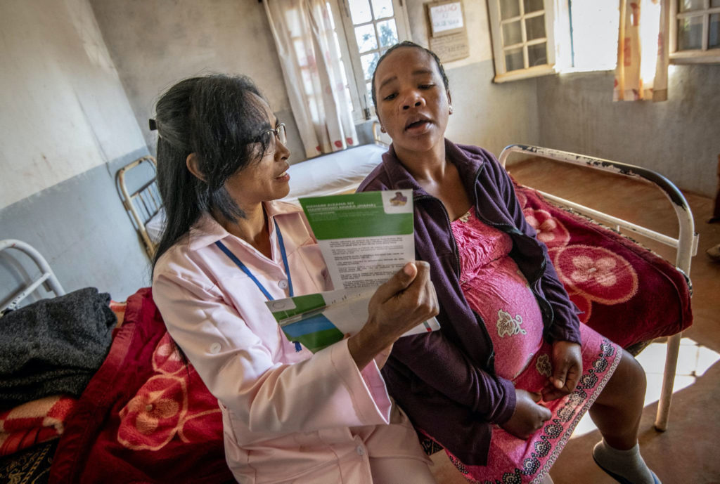 Midwife in Madagascar talks to a pregnant woman about the importance of prenatal care and nutrition during pregnancy.