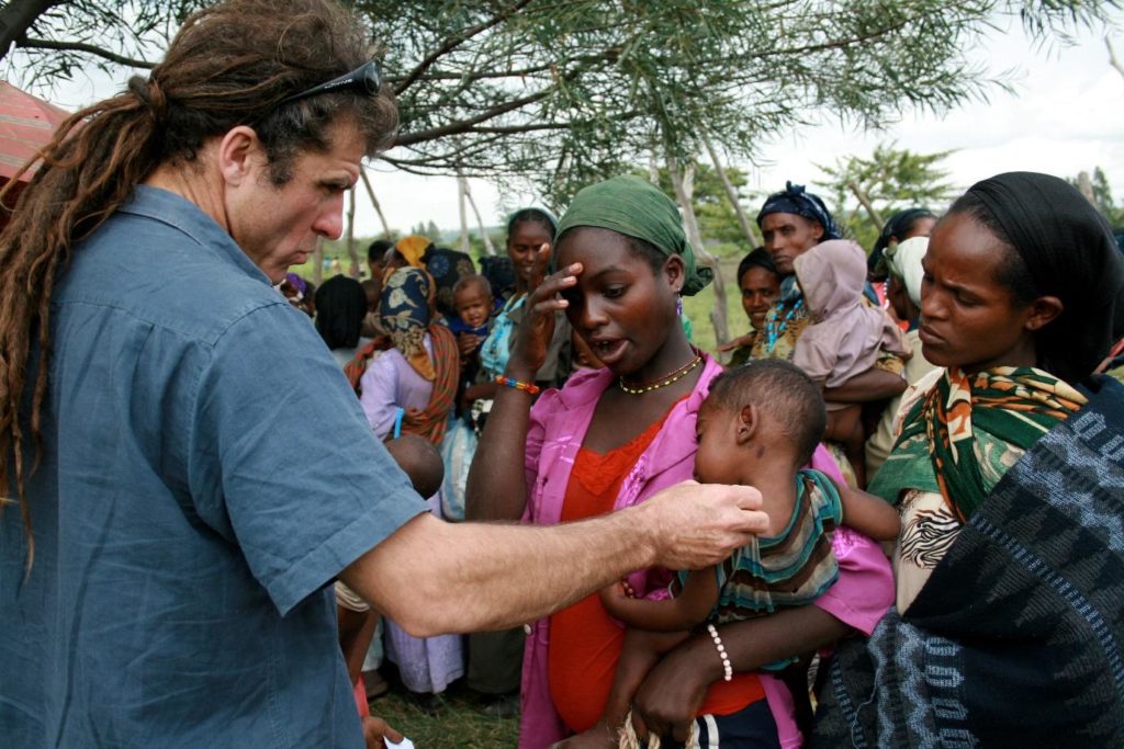 Dr Steve Collins (our Founder) with mother and child in Malawi